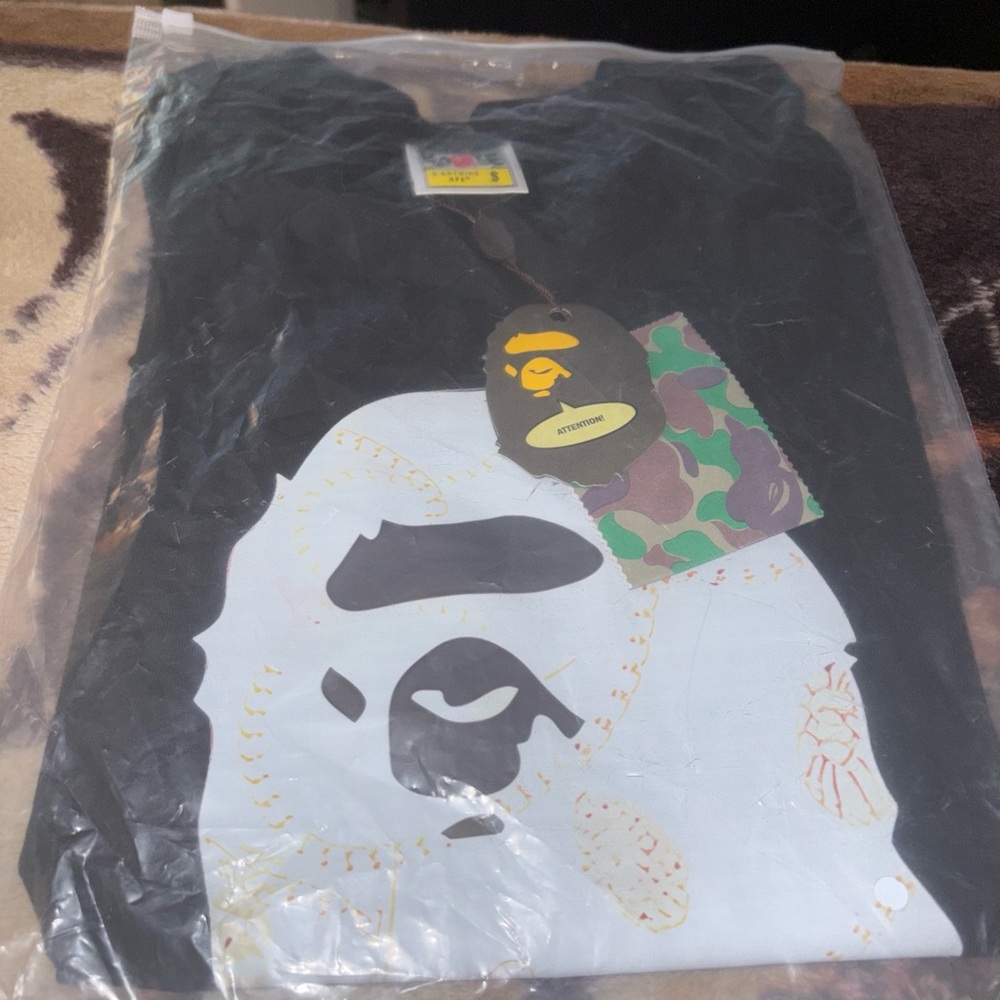 Bape Black T-Shirt with White Ape Face Graphic and Green Camo Tag